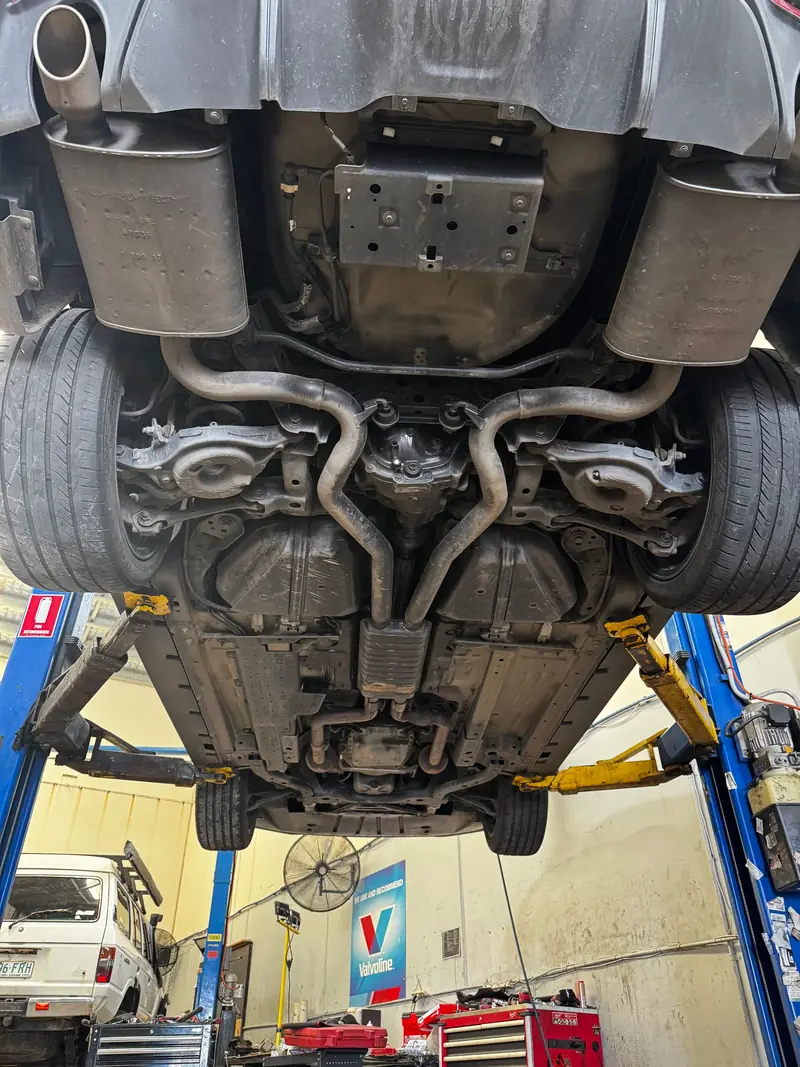 Underbody and exhaust of a car on the hoist