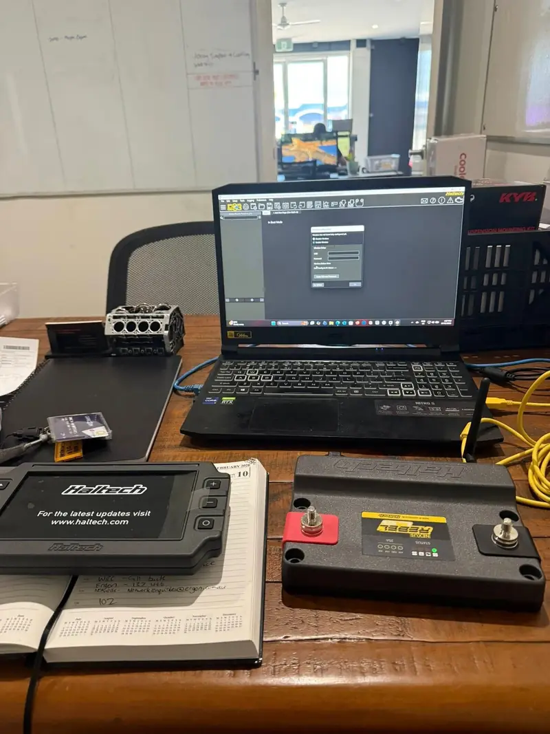 Haltech ECU and tuning laptop set up on the workbench for a performance tune
