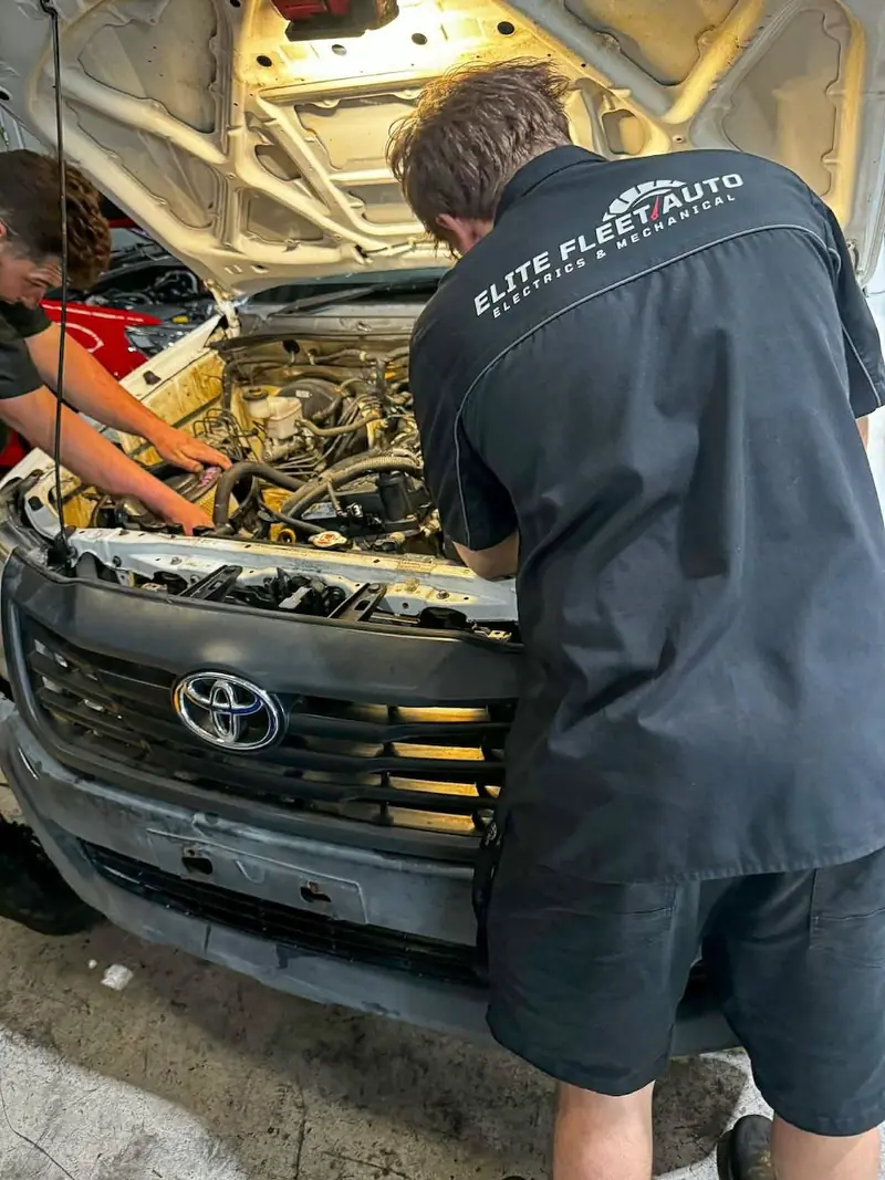 Elite Fleet Auto technician servicing a Toyota work vehicle
