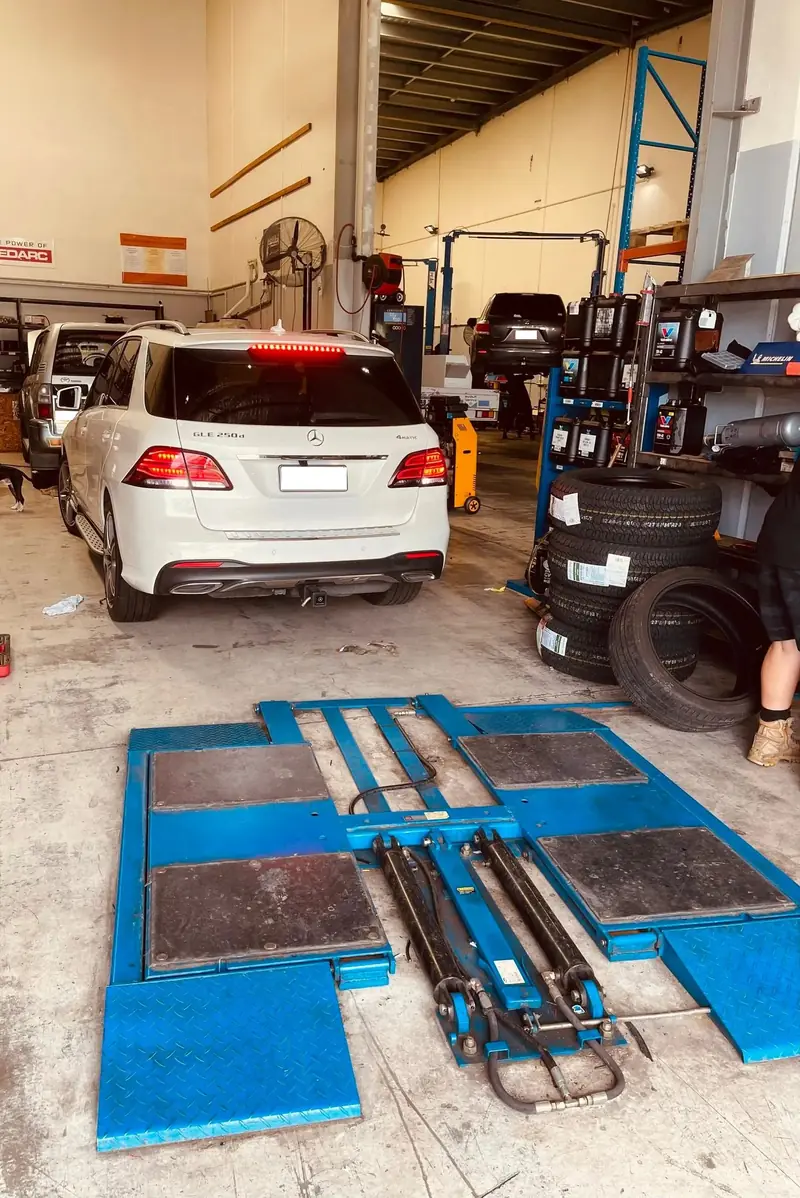 Wheel alignment bay with a car ready for alignment